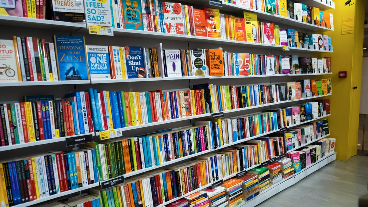 Rows of colourful books on shelves in a bookshop