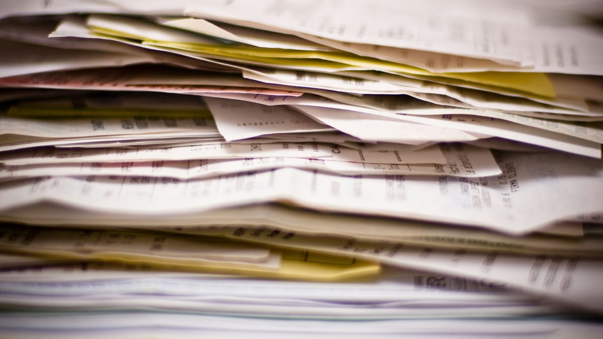 A thick stack of invoices and papers seen close up