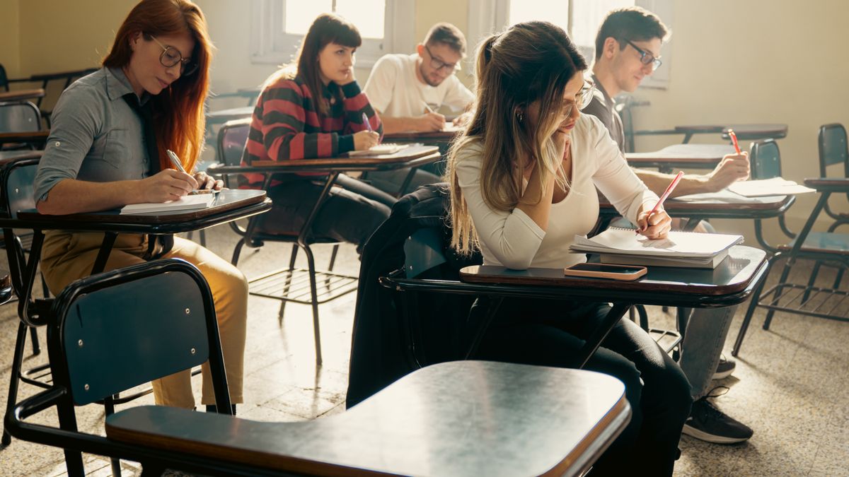 Senior school students working at their desks in a sunlit classroom