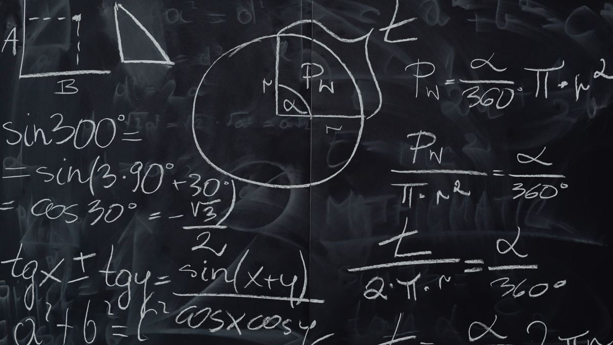 Mathematical equations and geometry diagrams written on a blackboard