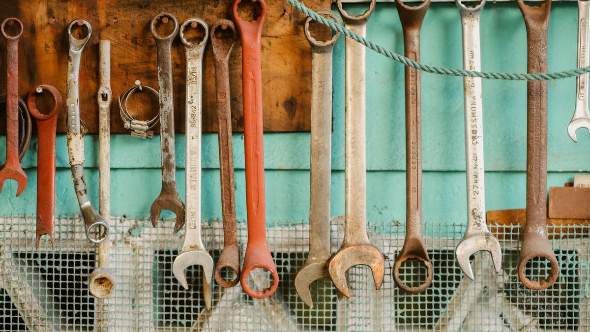 A row of wrenches hanging on a workshop wall